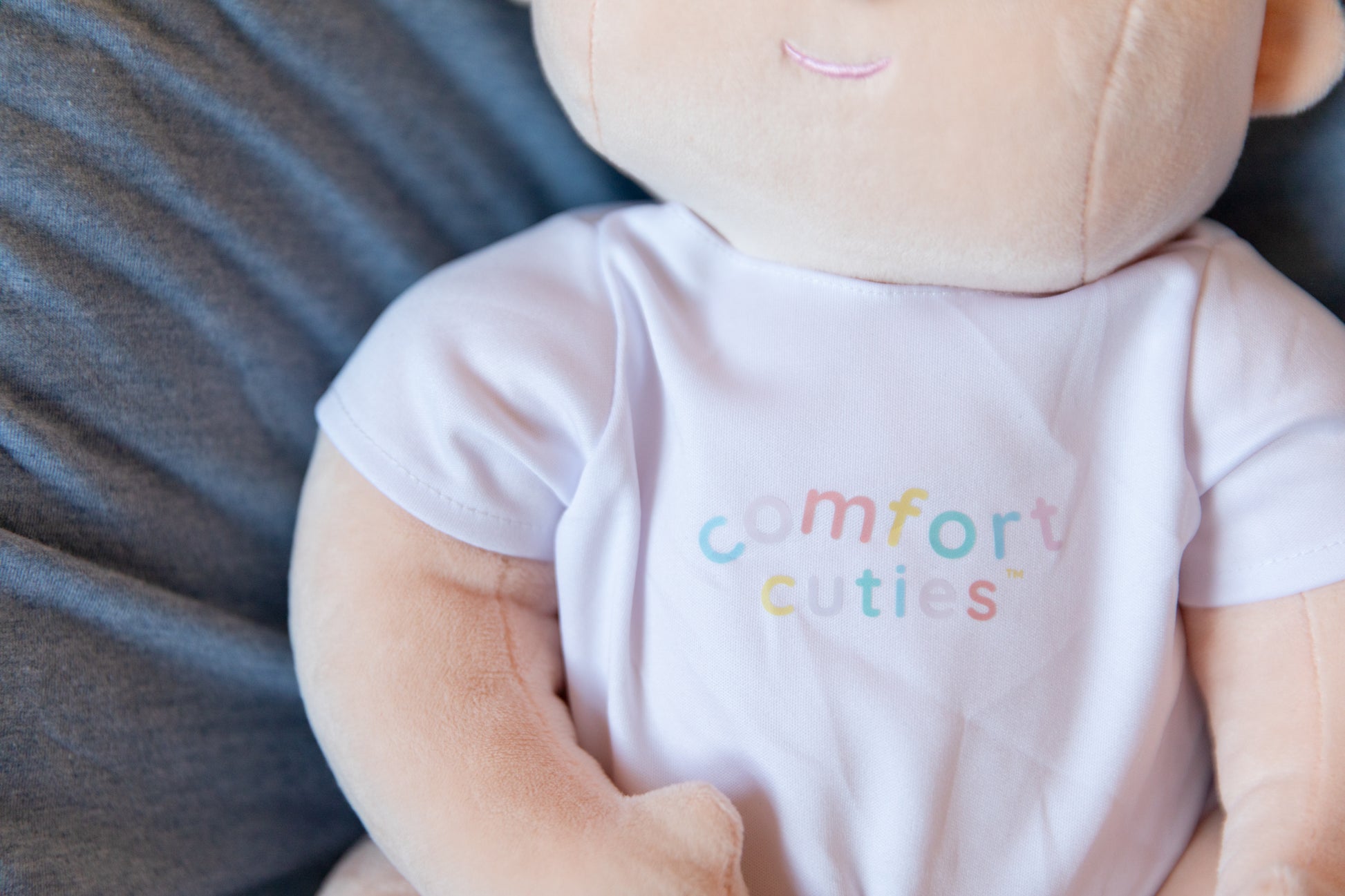 weighted cloth baby doll with comfort cuties branded onesie